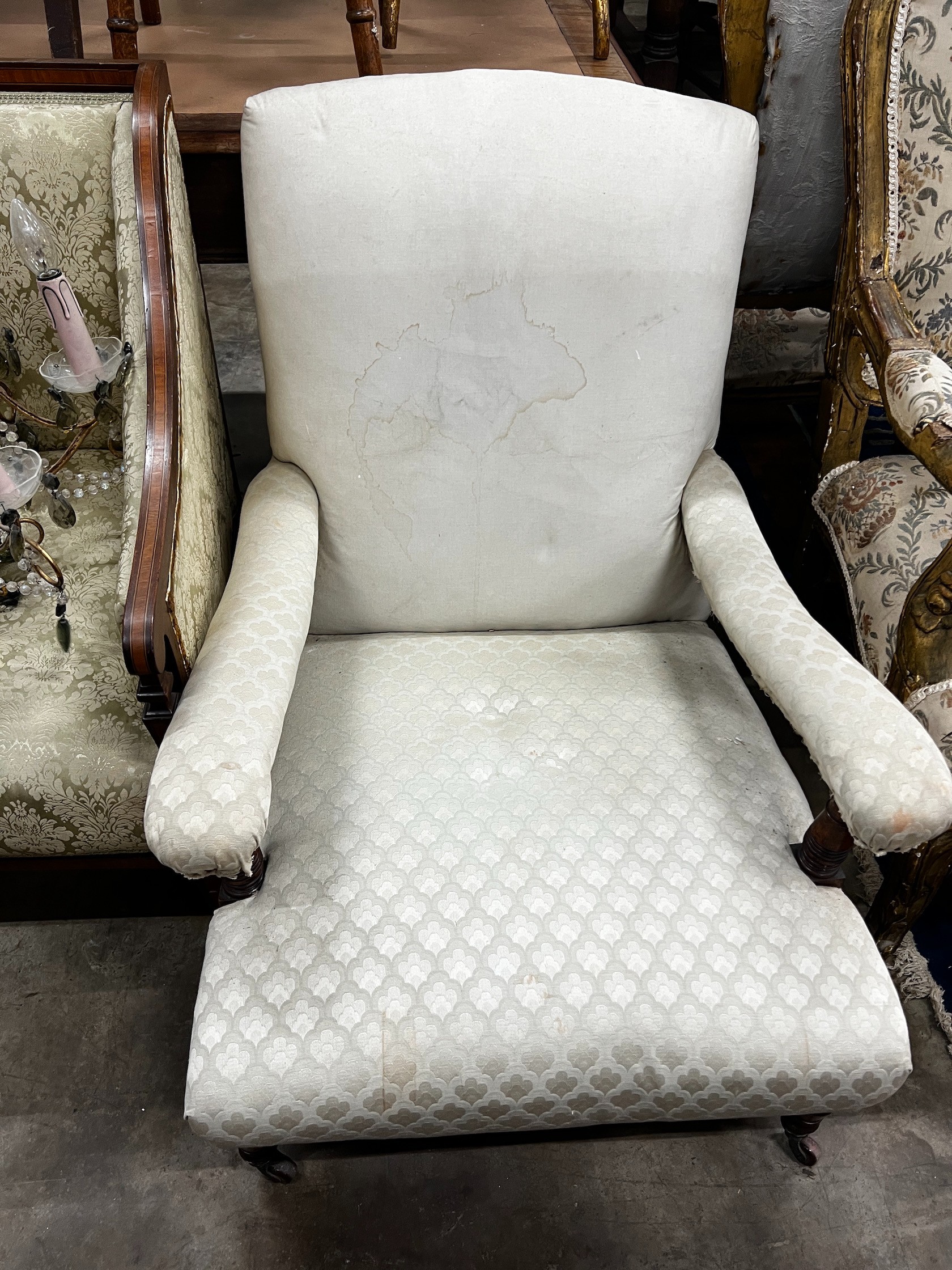 A late Victorian Howard style oak upholstered open armchair, width 69cm depth 90cm height 80cm (back legs cut)
